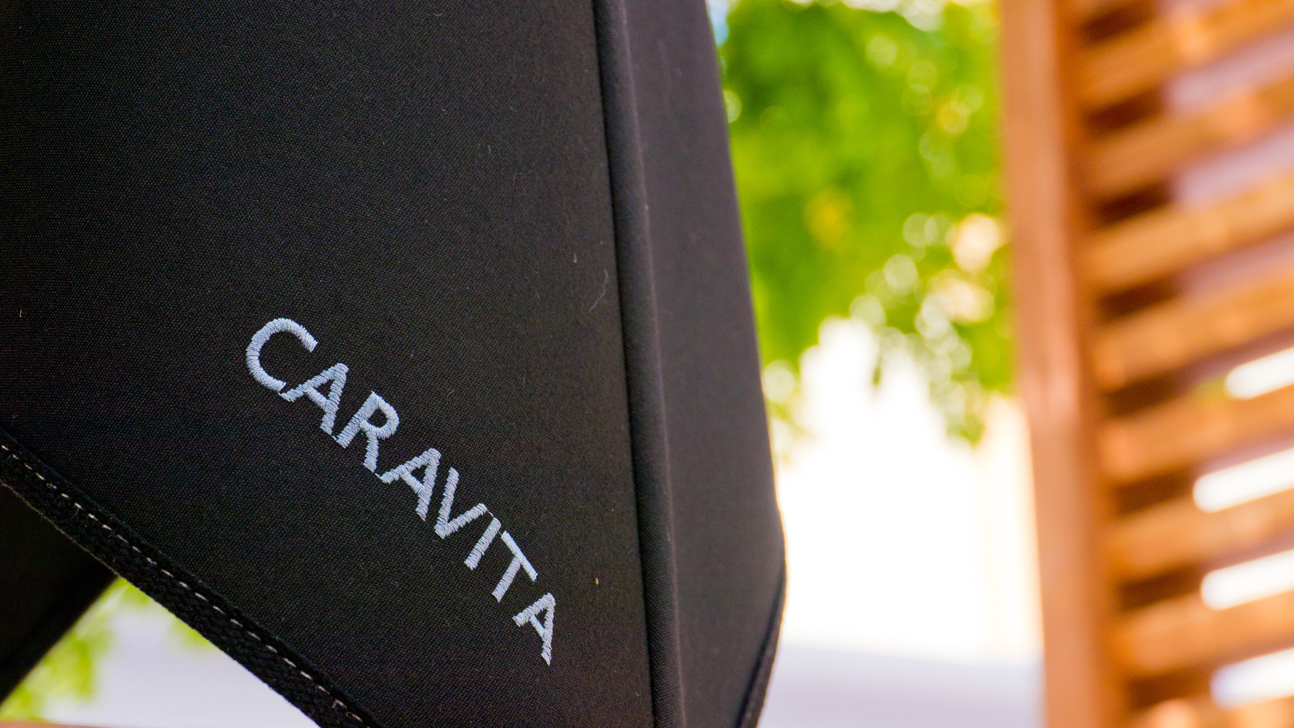 The CARAVITA name stitched into a black canopy beside its seam.