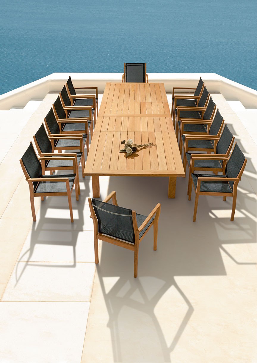 sling armchairs and a circular dining table viewed from above on a terrace